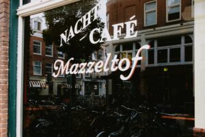 Nacht cafe sign reflected in a window in Amsterdam
