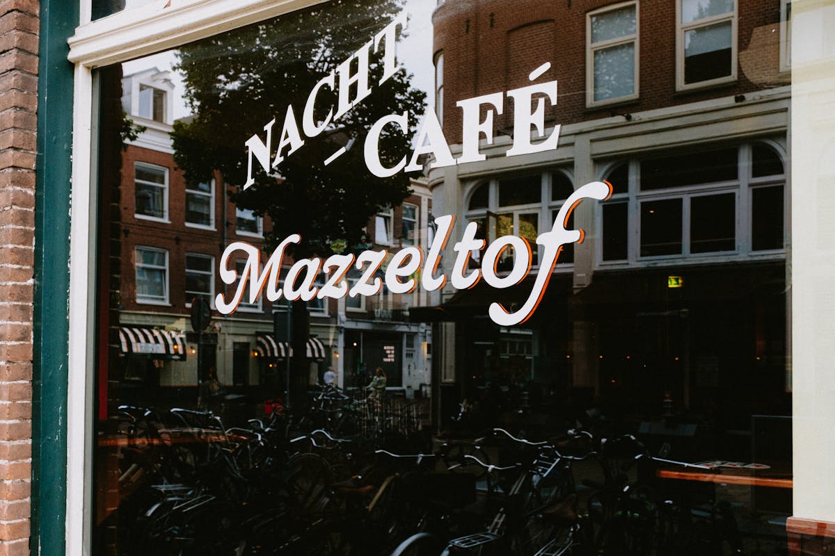 Nacht cafe sign reflected in a window in Amsterdam